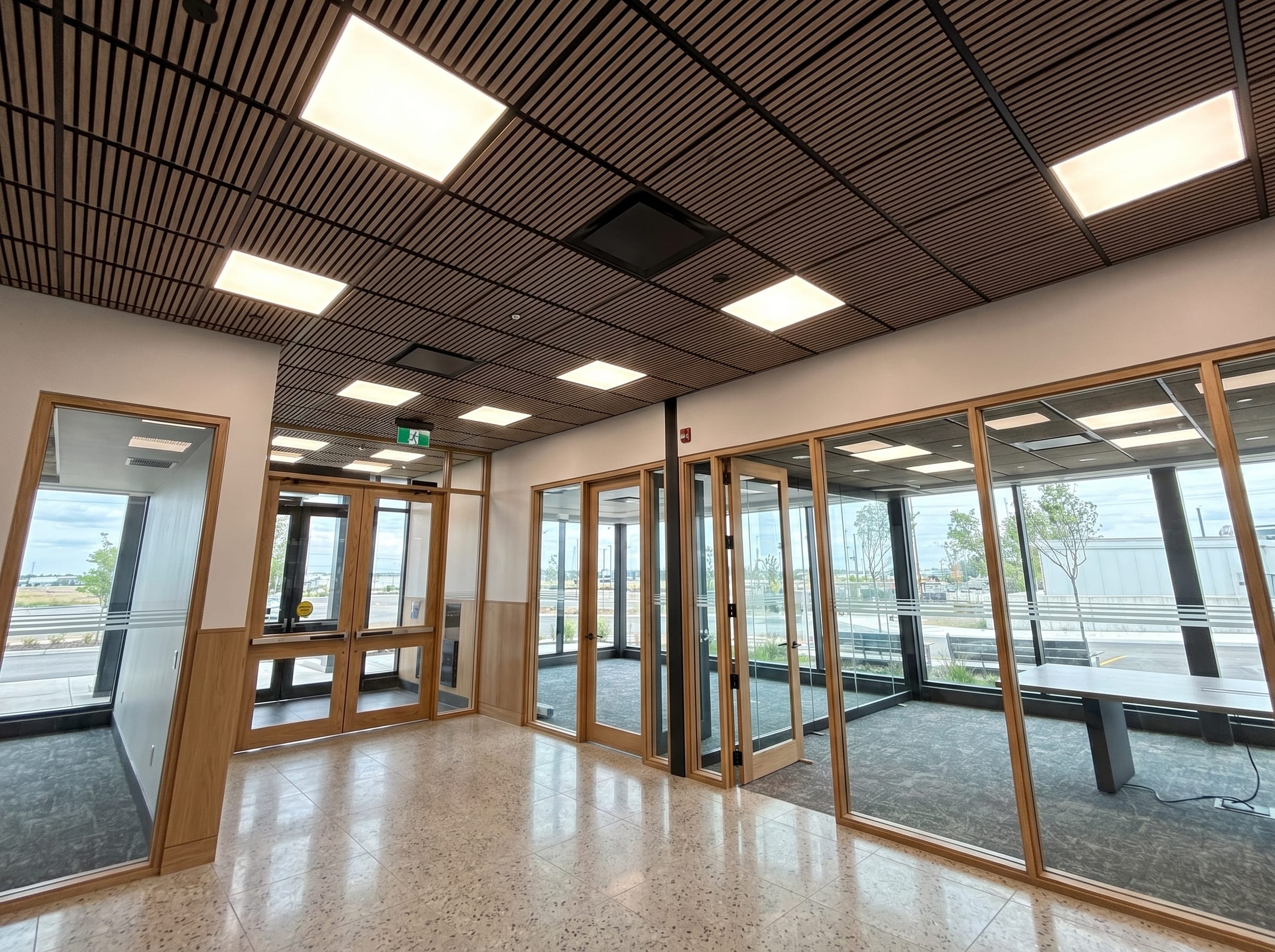 Finished acoustic panel ceiling in a modern corporate boardroom with clean geometry