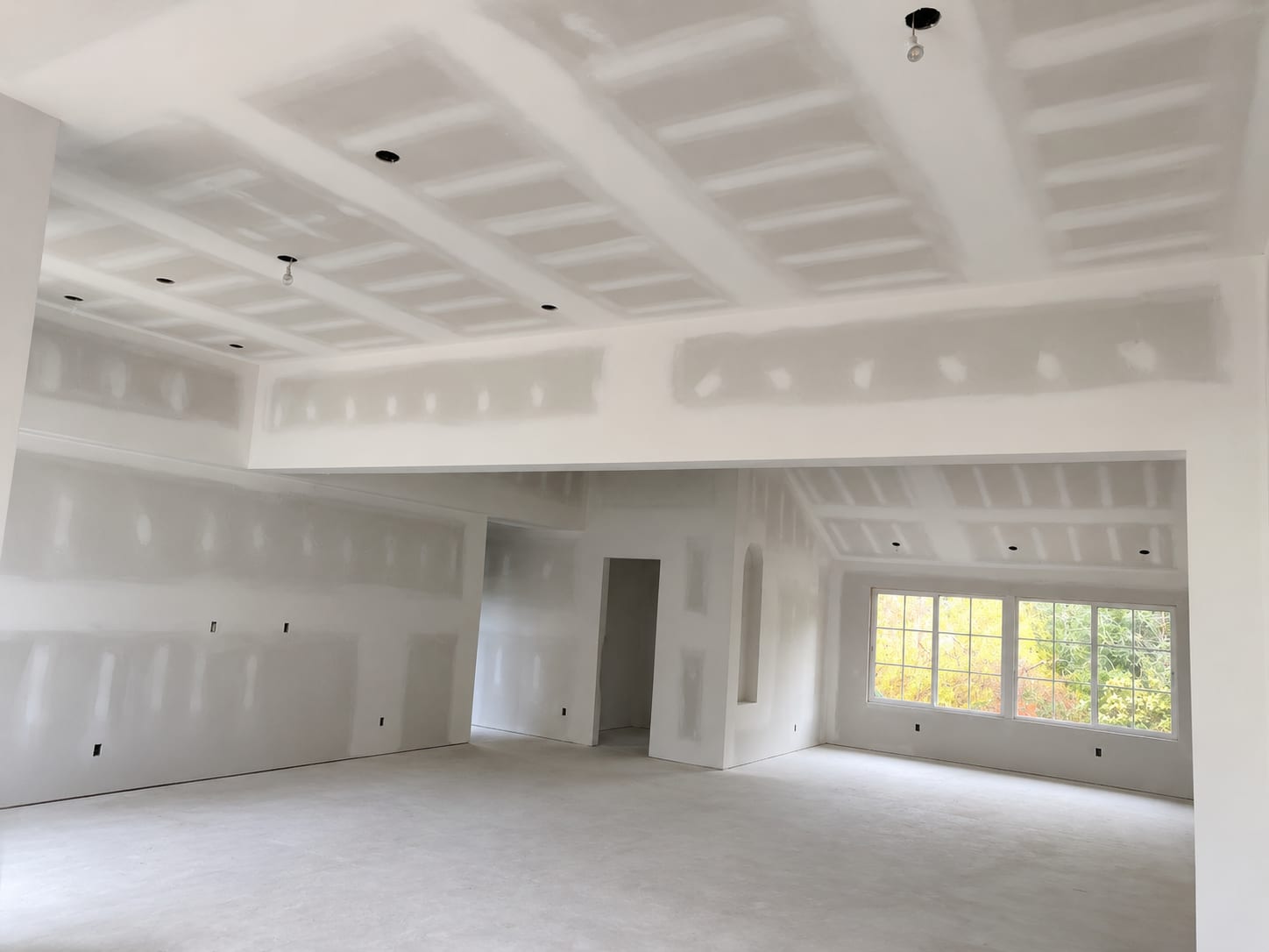 Close-up of a freshly finished drywall wall with a perfect smooth joint line
