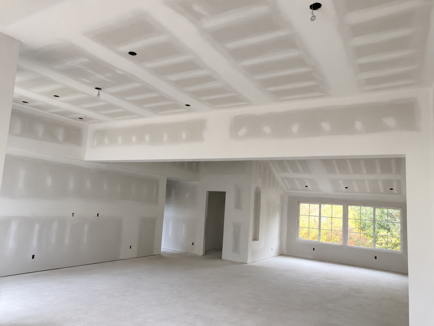 Close-up of a freshly finished drywall wall with a perfect smooth joint line