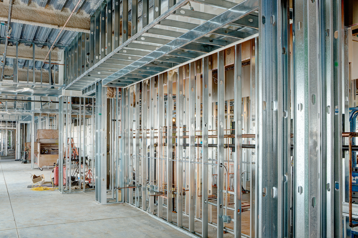 Steel stud framing grid in a large commercial building showing geometric precision